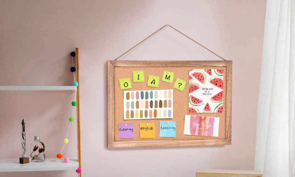 Emfogo framed cork board hanging on a pink wall